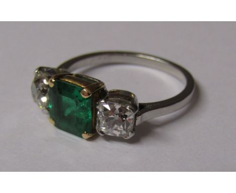 Tested as platinum ring set with central square emerald - 1.50ct - in yellow gold mount flanked by 2 square diamonds approx. 