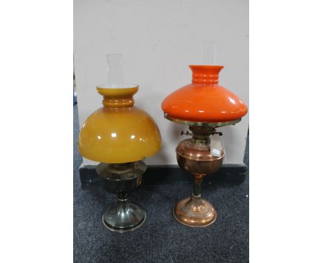 A brass oil lamp with orange glass shade and chimney together with an Aladdin chrome oil lamp and glass shade with chimney 