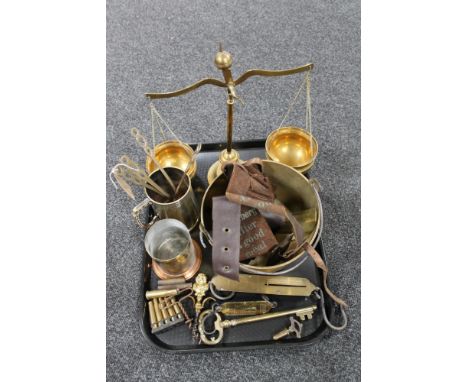 A tray of antique and later brass ware, balance scales, jam pan, spring balance, bullet casings, brass key and bottle openers