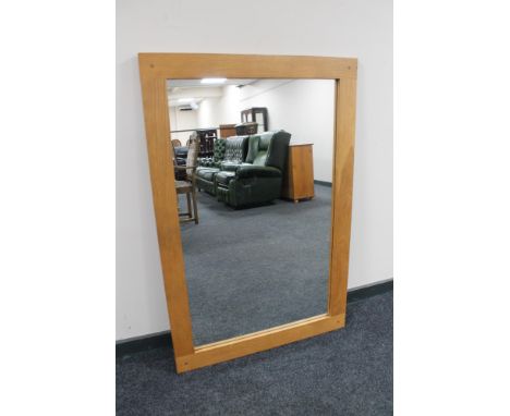 A contemporary oak overmantel mirror 