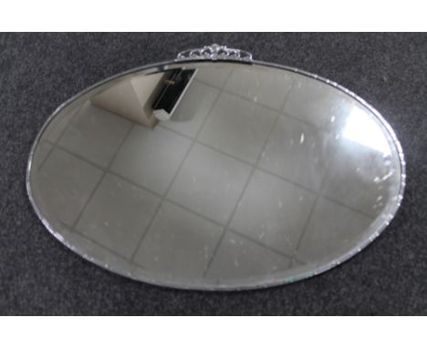 A 1930's oval chrome framed bevelled mirror 