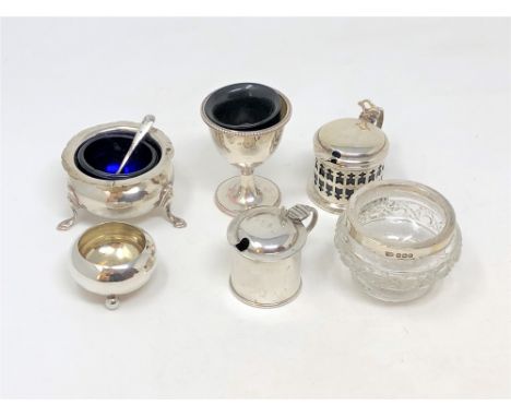 Two silver salts, two silver mustard pots, a silver egg cup, a silver and cut glass salt and two caddy spoons. (8)