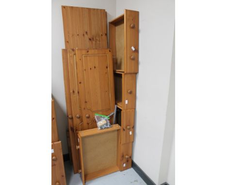 A pine triple door wardrobe with mirror door, fitted five drawers beneath (dismantled) 