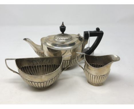 A three piece silver bachelor tea set, London 1911 CONDITION REPORT: 412g. Teapot with very small dent to foot. Sugar bowl wi