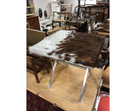 A 20th century cow hide upholstered lamp table on metal X-framed support 