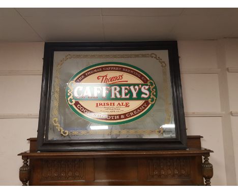 An antique and later overmantel mirror, with Thomas Caffrey's Irish Ale advertising,  130 cm x 103 cm 