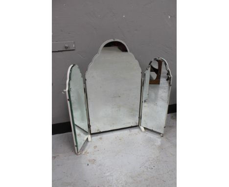 A frameless bevelled mirror on white painted stand 