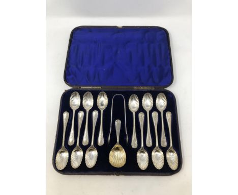 A Victorian cased set of twelve silver spoons, tongs and matching caddy spoon. 