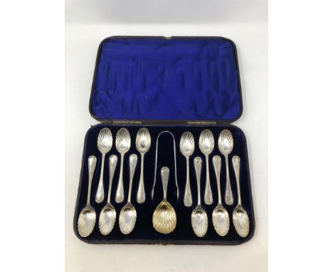 A Victorian cased set of twelve silver spoons, tongs and matching caddy spoon. 