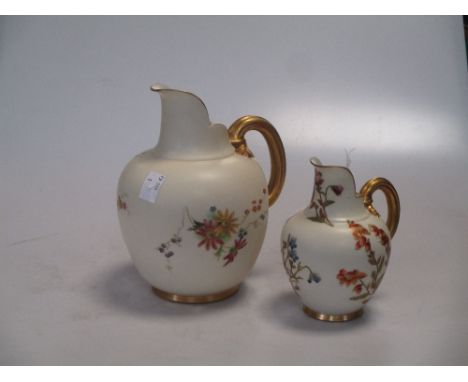 Two Royal Worcester floral ewers  