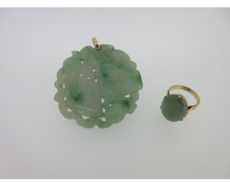 A late 19th century Chinese jadeite jade pendant together with a jadeite ring set in unmarked yellow metal testing for 14ct g