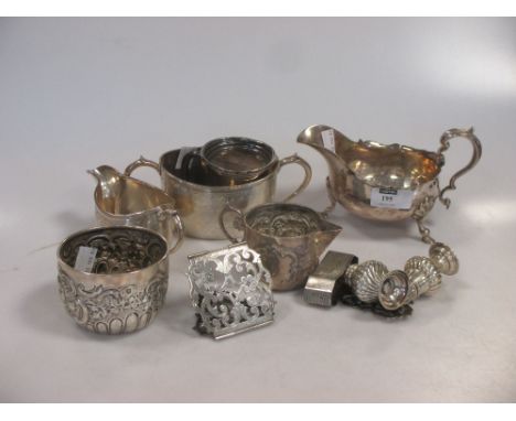 Silver: a sauceboat (marks rubbed), two cream jugs and sugar bowls, nurse's buckle, pepperettes, napkin ring, etc together 27