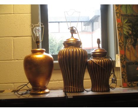 A modern gilt vase lamp and two similar (3)  