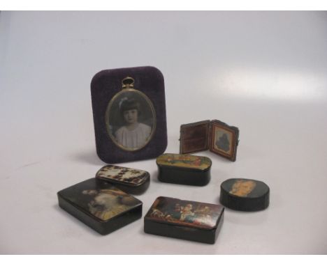 An early Victorian photograph of a young girl, in tooled leather folding frame, together with an oval photographic portrait m