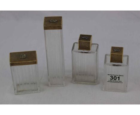 Four Asprey silver gilt topped cut glass dressing table jars, rectangular form with engine turned decoration to lids, each mo