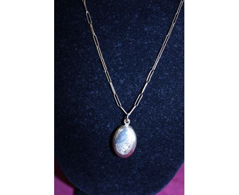 A 14ct gold locket on a 9ct gold paper chain 