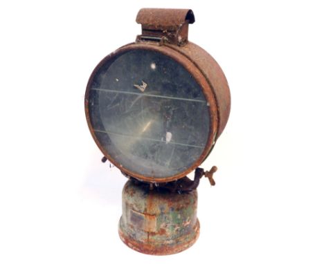 A railway inspection lamp, with metal casing on a mounted base, with three sectional glass plate and rubbed stamps, 65cm high