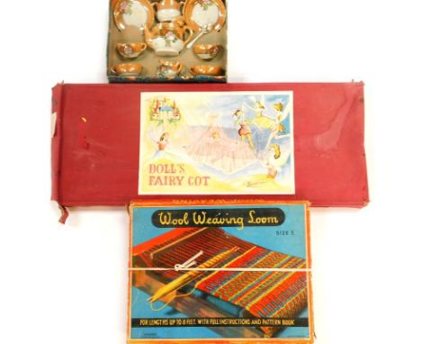 A wool weaving kit, doll's fair cot, and a doll's tea service, boxed. (3)