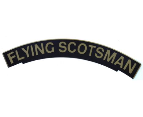 An arched railway engine sign The Flying Scotsman, on wooden backing, painted on black ground with gold lettering, 113cm wide
