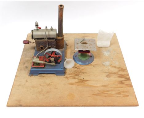 A Willis Co tin plate steam engine, and circular saw mounted to ply board. (2)