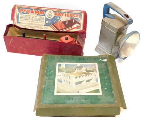 A BGL Pyramid Patience game, Lot Bricks factory building set, and an Everready hand held battery lamp. (3) 