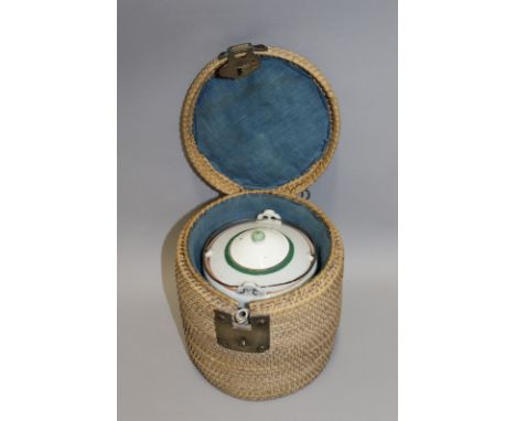 A CHINESE PORCELAIN TEAPOT, circa 1900, with matched cover and with fitted wicker work container, the sides of the cylindrica