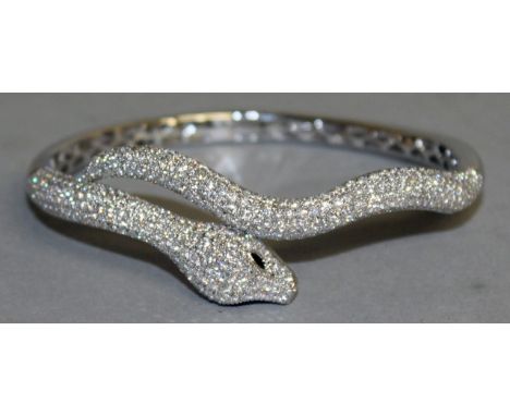 A SUPERB 18CT WHITE GOLD SNAKE HINGED BANGLE, set with approximately 7cts of diamonds.