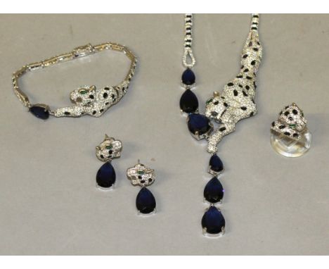 A SUPERB SUITE OF SILVER 'CARTIER' DESIGN RUBY MOUNTED JEWELLERY, comprising necklace, bracelet, pair of earrings and ring.