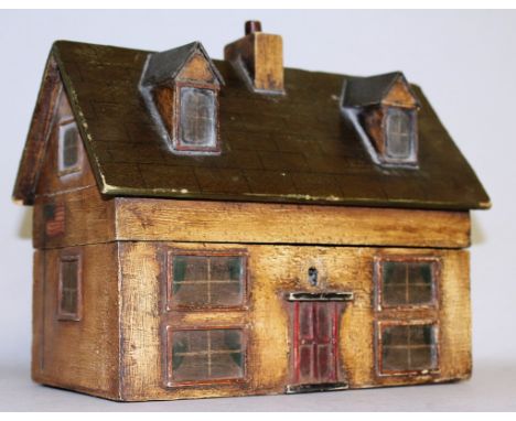 A GEORGIAN PAINTED WOOD HOUSE TEA CADDY with front and back door windows and chimneys. 8ins long, 4.5ins wide, 6ins high.