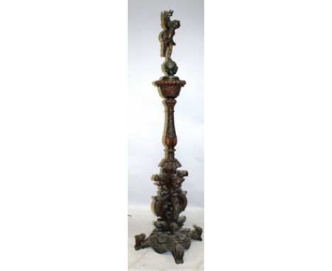 A CHINESE ROSEWOOD CARVED LAMP STANDARD, the base profusely carved with dragons, with a foliate carved column later surmounte