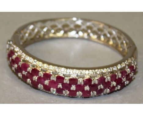 A GOOD SILVER THREE ROWS OF RUBIES BANGLE.