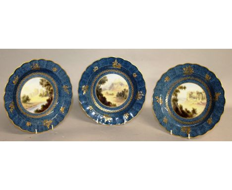 A SET OF THREE ROYAL WORCESTER PLATES, Alnwick, Montgomery and Carew Castle painted by G. Johnson.  8ins diameter.