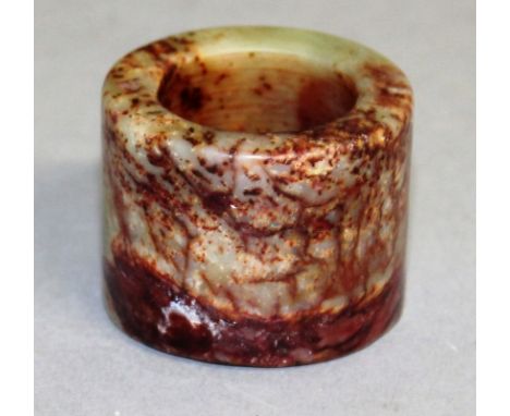 A JADE THUMB RING.