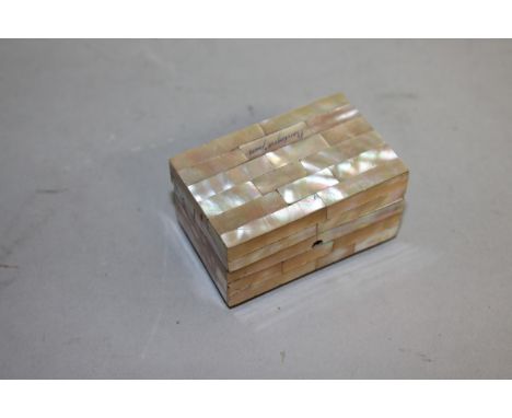 A SMALL MOTHER-OF-PEARL RECTANGULAR BOX on bun feet. 2.5ins x 1.5ins x 1.25ins.