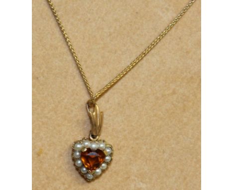 A TOURMALINE AND PEARL HEART SHAPED PENDANT on chain.