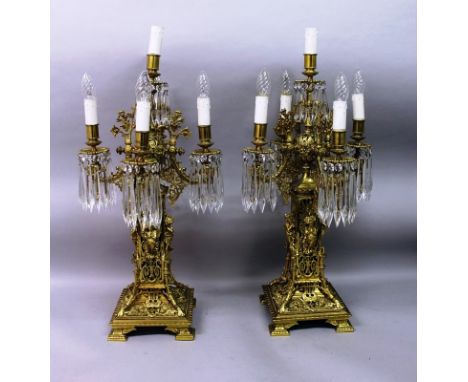 A SUPERB PAIR OF FRENCH BRASS FIVE LIGHT CLASSICAL CANDELABRA, each with four scrolling branches, cut prism drops, mounted wi