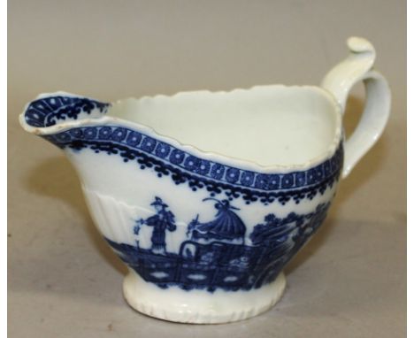 AN 18TH CENTURY CAUGHLEY SAUCEBOAT of unusual moulded shape printed with two chinoiserie scenes. Provenance: Panes Collection