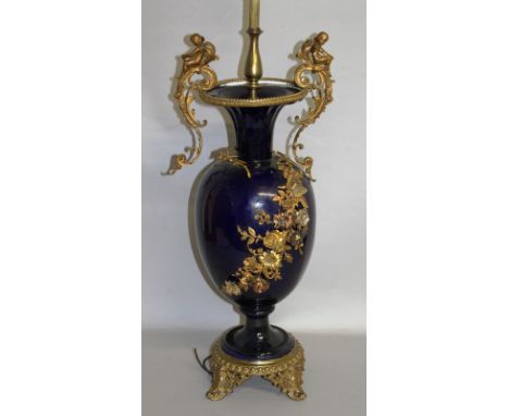 A SEVRES STYLE BLUE PORCELAIN AND ORMOLU LAMP, with a pair of scrolling handles surmounted by cherubs, the body mounted with 