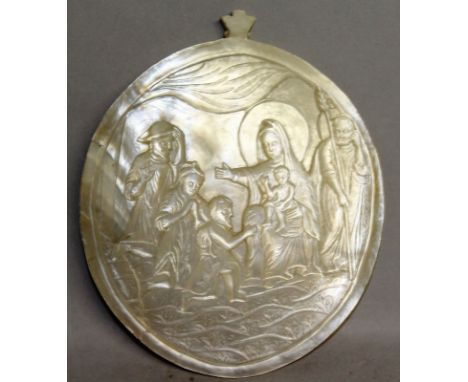 A CARVED MOTHER-OF-PEARL SHELL, Madonna and Child and The Three Kings. 3.25ins x 2.75ins.