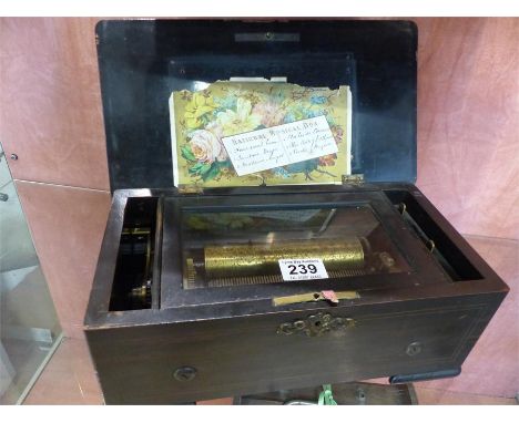 A National Musical box number 30801 with 6 1/4 inch cylinder playing six airs in a grained case. All pins present and correct