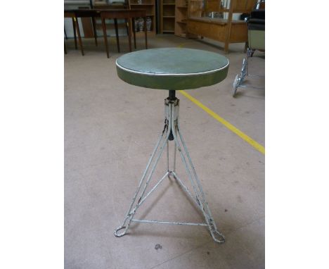 Factory metal mid century stool on tripod base and with a green leather seat