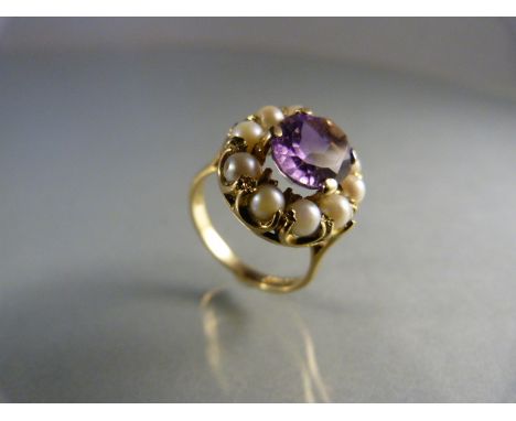 9ct Gold Amethyst and Pearl Ring. Central oval amethyst approx 10mm x 8mm surrounded by 10 approx 3.5mm pearls UK - M USA - 6