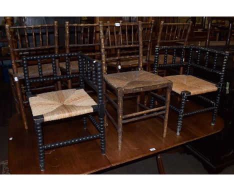 A set of five 19th century faux bamboo rush-seated chairs with spindle-backs, together with two ebonised bobbin-turned corner