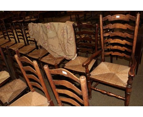 A set of nine rush seated ladder back chairs, including two carvers (9)