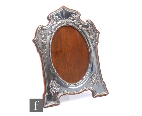 An Edwardian hallmarked silver rectangular easel photograph frame embossed with floral swags around oval aperture and within 