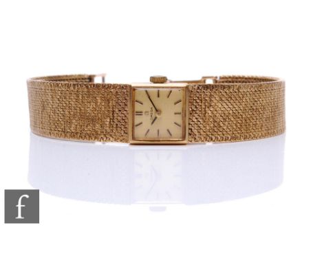 A lady's 9ct hallmarked Omega manual wind wrist watch, gilt batons to a square champagne dial to an integral mesh bracelet, t