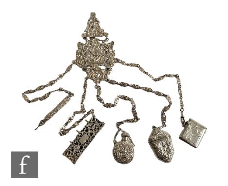 A Victorian hallmarked silver chatelaine, three embossed decorated panels depicting Neptune and foliate scrolls above five ch