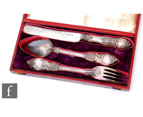 A cased Russian silver knife, fork and spoon set each with shell and foliate scroll decoration,&nbsp;St Petersburg 1845, Karl