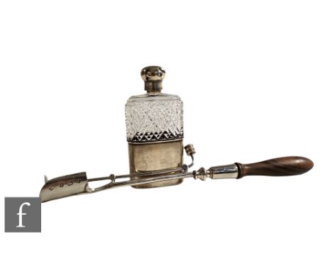 A hallmarked silver stilton scoop with push action and turned wooden handle, with a similar silver and clear glass hip flask&