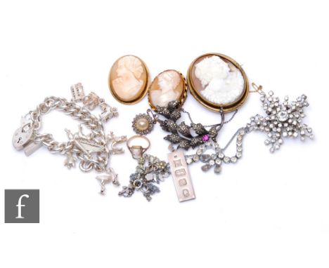 A silver curb link charm bracelet with a silver ingot three cameo brooches and a similar ring etc. (qty) 